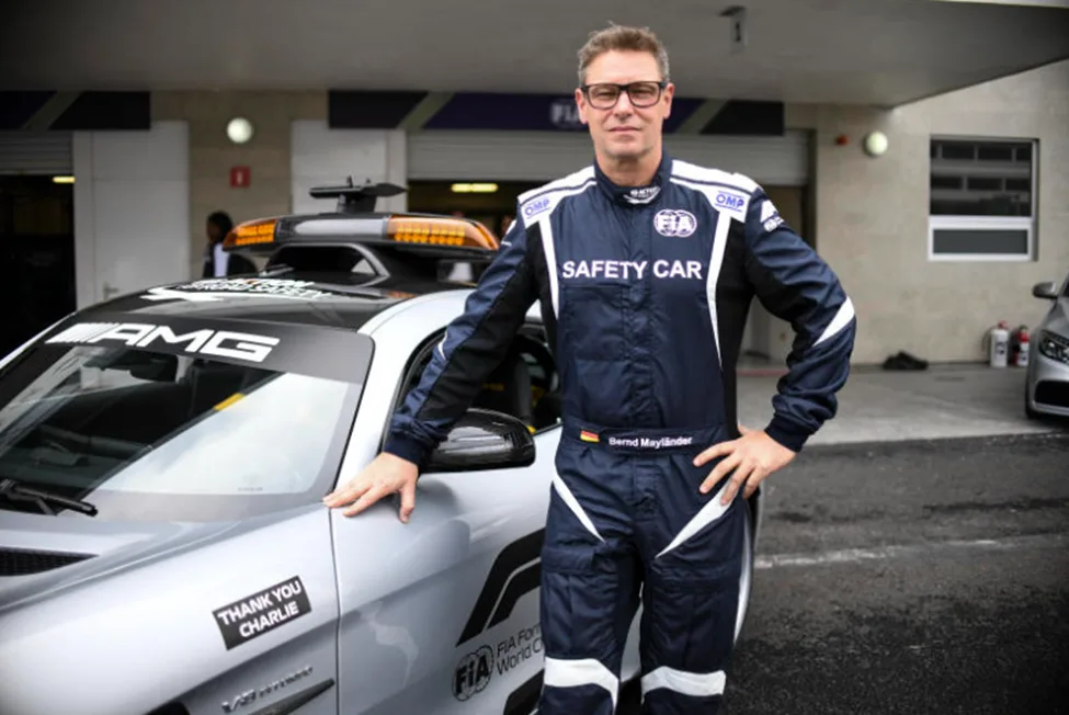 Bernd Mayländer standing beside the Mercedes-AMG F1 Safety Car