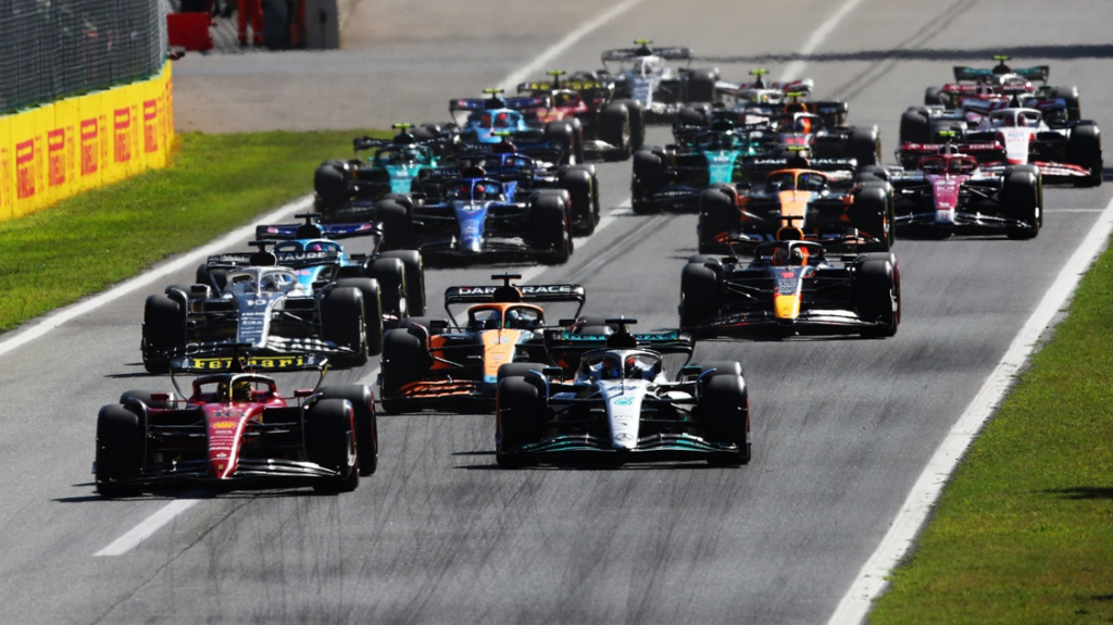 F1 cars racing through the field at race start